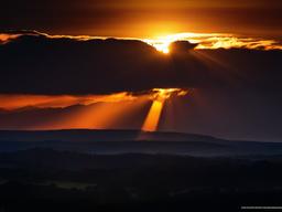 Sunset Wallpaper - Sunlight bursting through dark clouds.  sunset background