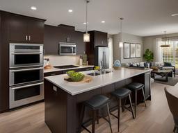 Contemporary kitchen is designed with laminate countertops, energy-efficient appliances, and an island for casual dining, perfect for family gatherings.  